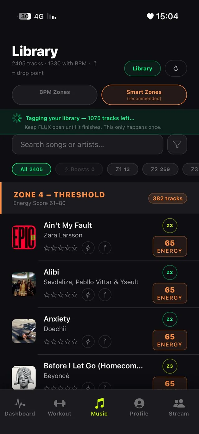 Library screen with a green banner showing Tagging your library, 1075 tracks left, keep FLUX open until it finishes